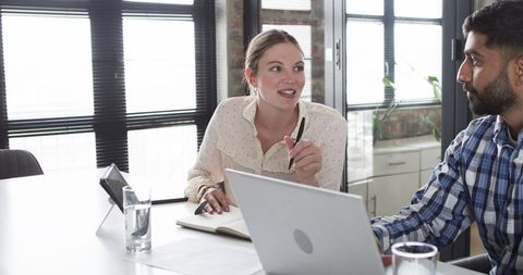 Teamwork in Modern Office with Young Professionals Using Technology