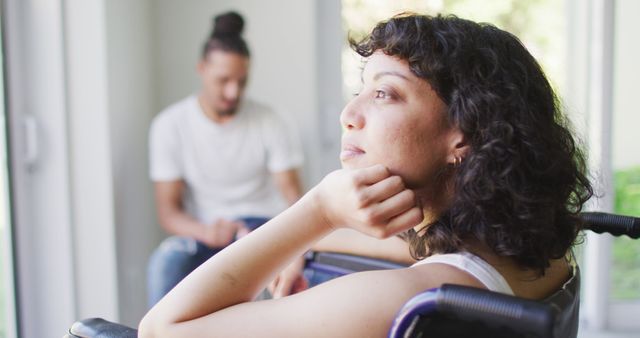 Smiling biracial woman in wheelchair at home with male partner using smartphone - Download Free Stock Photos Pikwizard.com