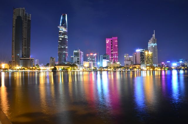 Vibrant Ho Chi Minh City Skyline at Night with Colorful Reflections - Download Free Stock Photos Pikwizard.com