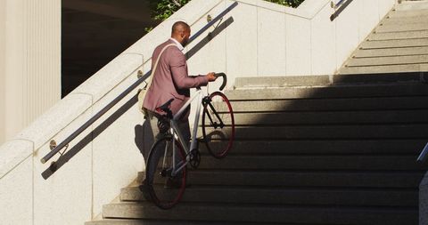 Man Carrying Bicycle Up City Stairs in Urban Environment - Download Free Stock Images Pikwizard.com