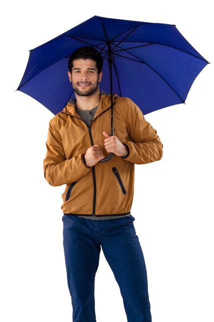 Portrait of smiling man standing under umbrella against white background