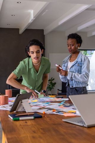Creative collaboration brainstorming over sketches sticky notes on wooden workspace table