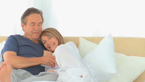 Senior Couple Enjoying Relaxing Morning in Bed