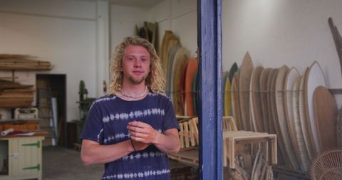 Artisan Surfboard Maker Standing in Workshop Doorway