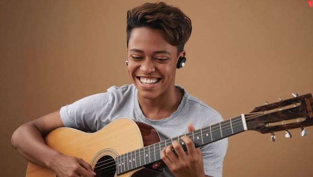 Smiling Young Musician Strumming Acoustic Guitar in Minimalist Studio