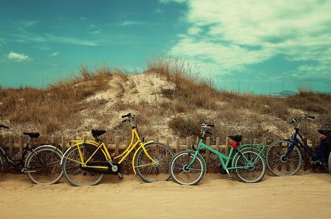 Colorful Bicycles at Sandy Dunes with Clear Blue Sky