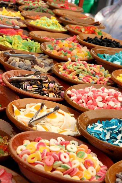 Assorted Colorful Candies Displayed in Clay Bowls at Market - Download Free Stock Photos Pikwizard.com