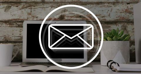 Pulsing email notification over laptop on rustic desk, remote work inbox alert