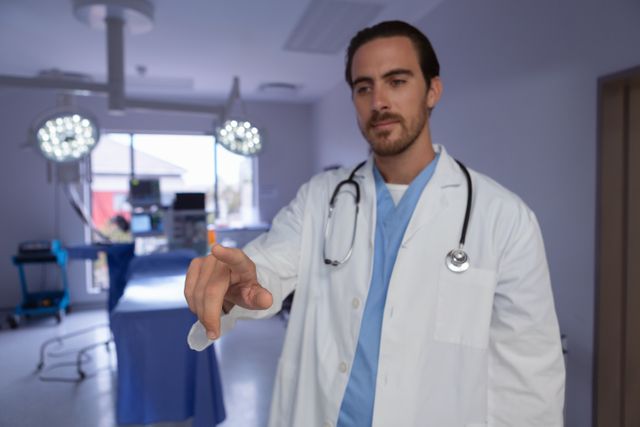 Male doctor interacting with invisible screen in a modern operating room. Ideal for use in healthcare technology, medical advancements, hospital environments, and professional healthcare settings.