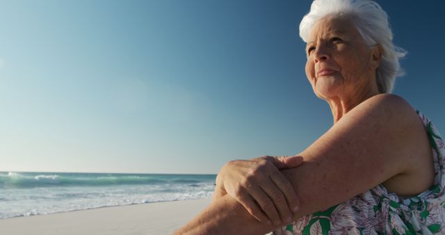 Elderly Woman Enjoying Ocean Breeze at Sunny Beach - Download Free Stock Images Pikwizard.com