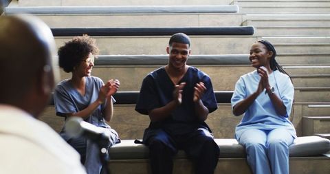 Healthcare professionals celebrating teamwork in hospital environment