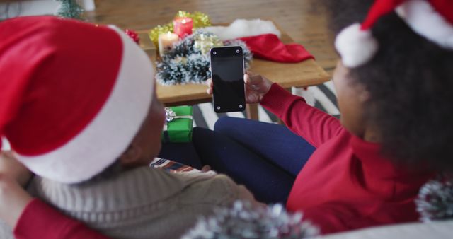 Mother and Daughter in Santa Hats Taking Selfie During Christmas - Download Free Stock Images Pikwizard.com