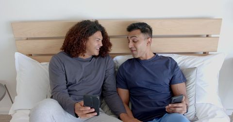 Happy Diverse Couple Enjoying Morning Communication on Bed