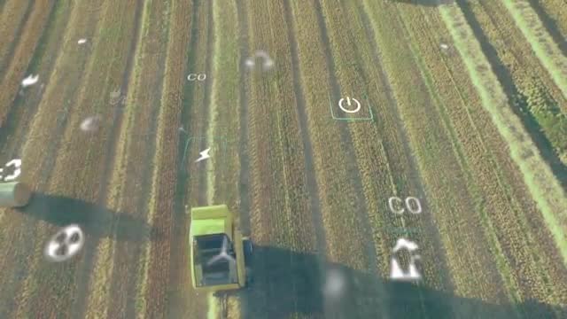 Bird’s-eye view of harvesting machine working in open field with transparent agricultural technology animations overlaid. Suitable for illustrating modern investments in farming technology, presentations on agricultural innovation, articles on sustainable practices and precision agriculture for improved food production efficiency.