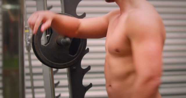 Muscular Man Adjusting Weight Plates on Gym Machine - Download Free Stock Images Pikwizard.com