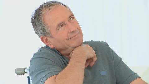 Older Man Pondering in Wheelchair at Home