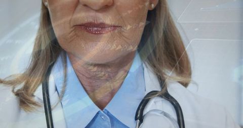 Senior female doctor smiling wearing stethoscope and white coat conveying warmth