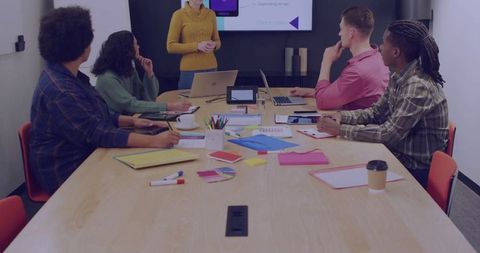 Diverse Team Collaborating in Business Meeting with Presentation