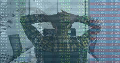 Businessman overwhelmed by financial data visualization