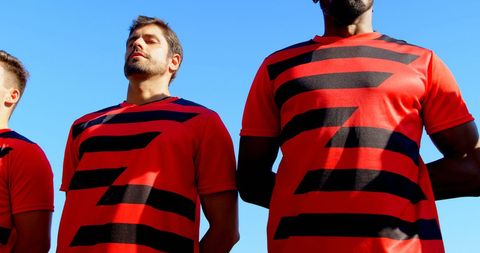 Football Players Singing Anthem Before Game