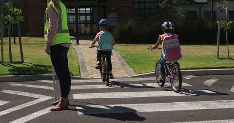Children Crossing Road with Safety Guidance on Bikes - Download Free Stock Images Pikwizard.com