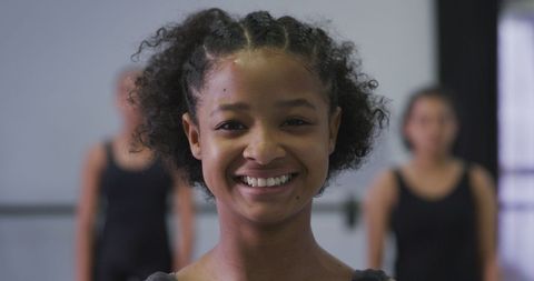 Smiling biracial dancer in contemporary class