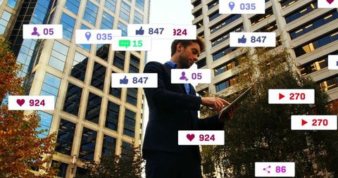 Businessman engaging with digital media in urban setting