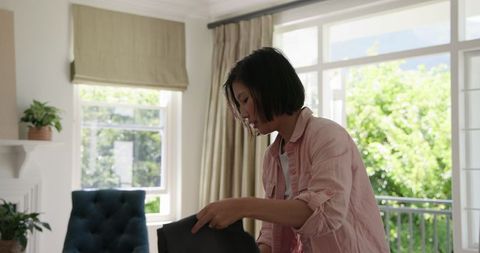 Woman packing clothes in suitcase at home for upcoming trip