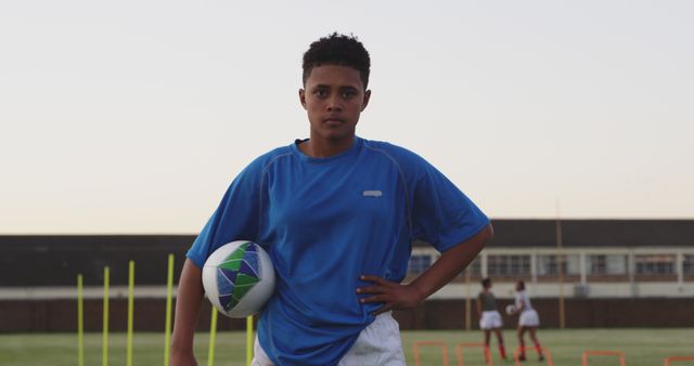 Focused Teenager Holding Rugby Ball During Practice - Download Free Stock Images Pikwizard.com