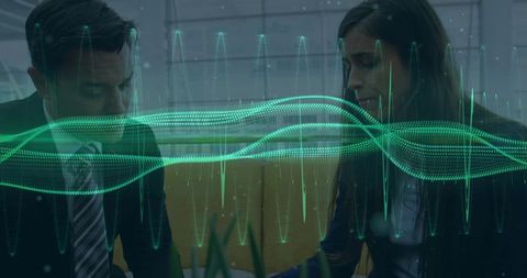 Professionals Analyzing Waveform for Data Solutions in Modern Office