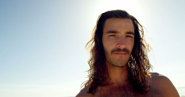 Man with Long Hair and Mustache under Sunlit Sky at Beach - Download Free Stock Images Pikwizard.com