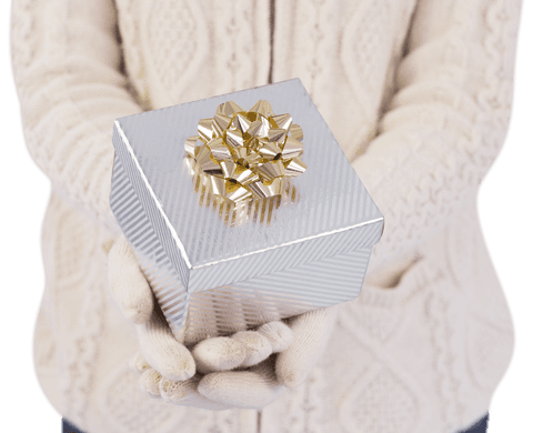 Close-up hands holding transparent elegant gift with gold bow