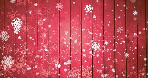 Snowflakes Falling on Red Wooden Background for Festive Season
