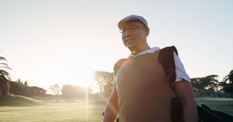Golfer Walking Across Golf Course in Early Morning Light - Download Free Stock Images Pikwizard.com