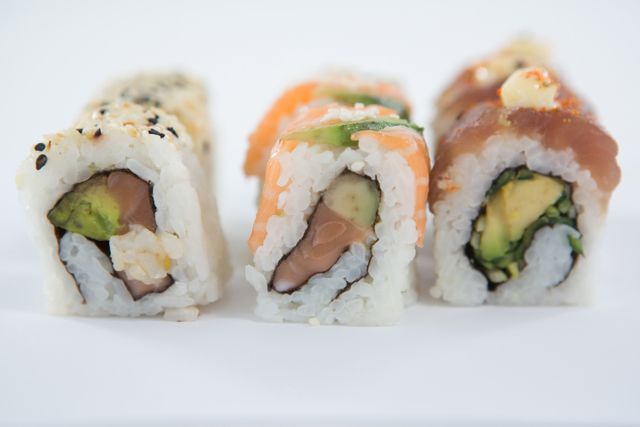 Close-up of uramaki sushi roll on white background