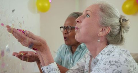 Diverse Women Celebrating with Confetti at Home Gathering
