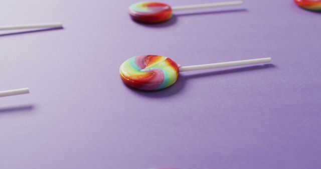 Colorful Swirl Lollipops on Purple Background - Download Free Stock Images Pikwizard.com