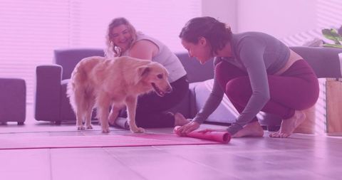 Women Setting Yoga Mats at Home With Golden Retriever
