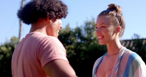 Joyful Couple Smiling in Sunlit Backyard