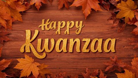 Happy kwanzaa gold glitter text on rustic wood background with autumn leaves fall border