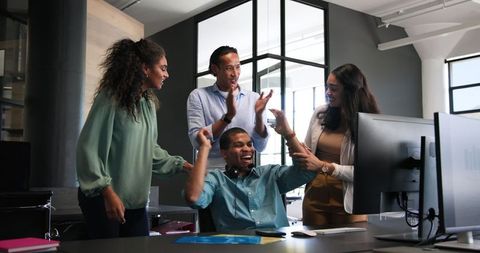 Happy Team of Multiethnic Colleagues Celebrating Work Success