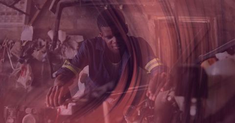 Skilled mechanic analyzing engine in dimly lit garage workshop