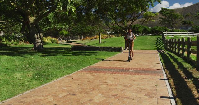 Person Riding Scooter in Scenic Park - Download Free Stock Images Pikwizard.com