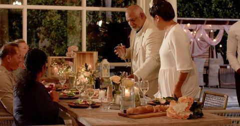 Elegant Wedding Celebration with Diverse Friends Enjoying Dinner in Garden