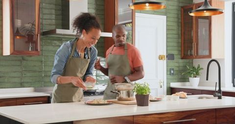 Diverse Couple Cooking Together at Home in Modern Kitchen