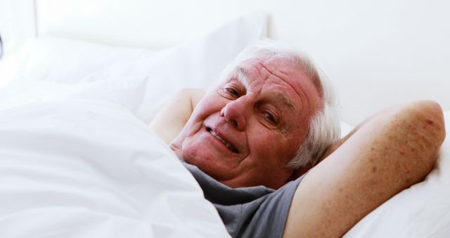 Elderly Man Smiling While Relaxing in Bed - Download Free Stock Images Pikwizard.com