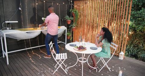 Romantic evening dinner on patio with intimate lighting