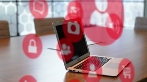 Digital Icons Hovering Over Laptop Displaying Connectivity
