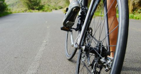 Close-Up Bicycle Wheel on Scenic Road Invites Outdoor Journey - Download Free Stock Images Pikwizard.com