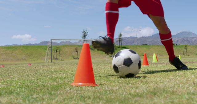 Soccer Player Training with Orange Cones on Field - Download Free Stock Images Pikwizard.com